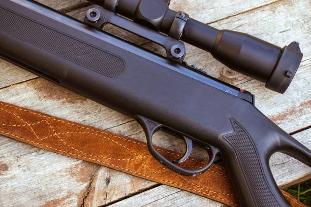 Black rruger1020.caifle with a telescopic sight on a wooden background. Close-up ruger1020.ca